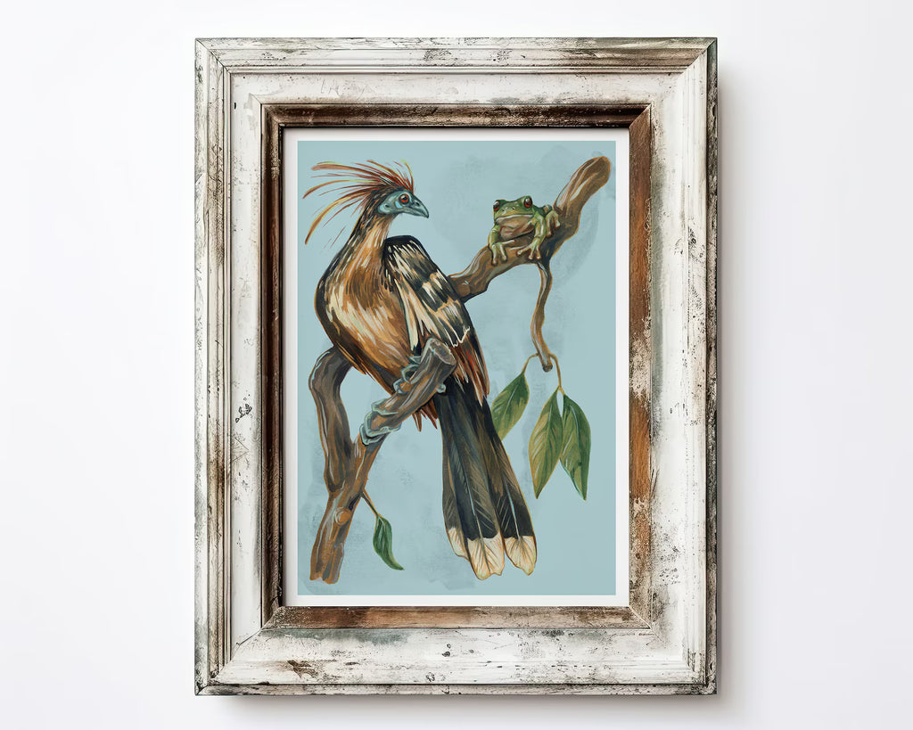 Framed artwork of a bird on a branch with leaves against a light blue background