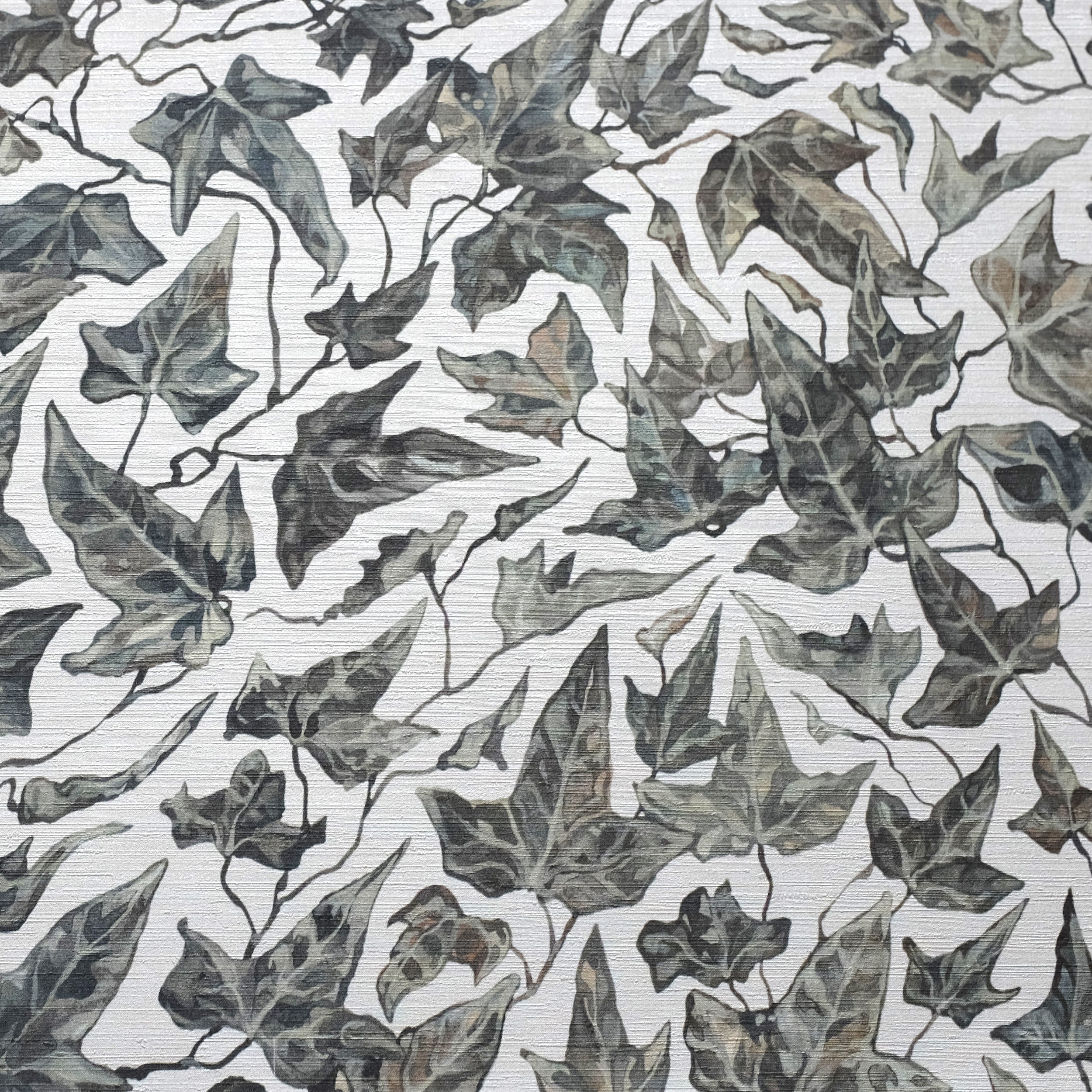 Close up of textured wallpaper featuring an ivy motif on a white background.