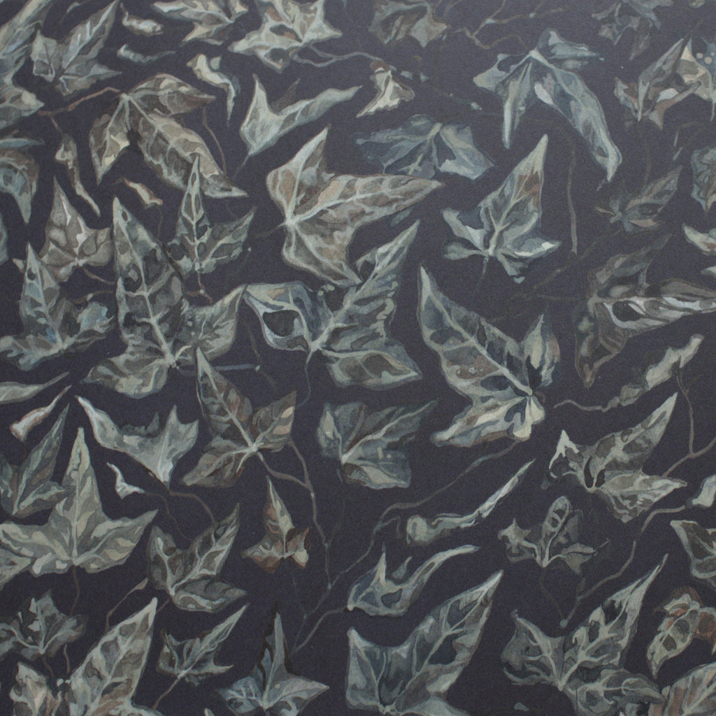 Close up of wallpaper featuring an ivy motif on a dark background.