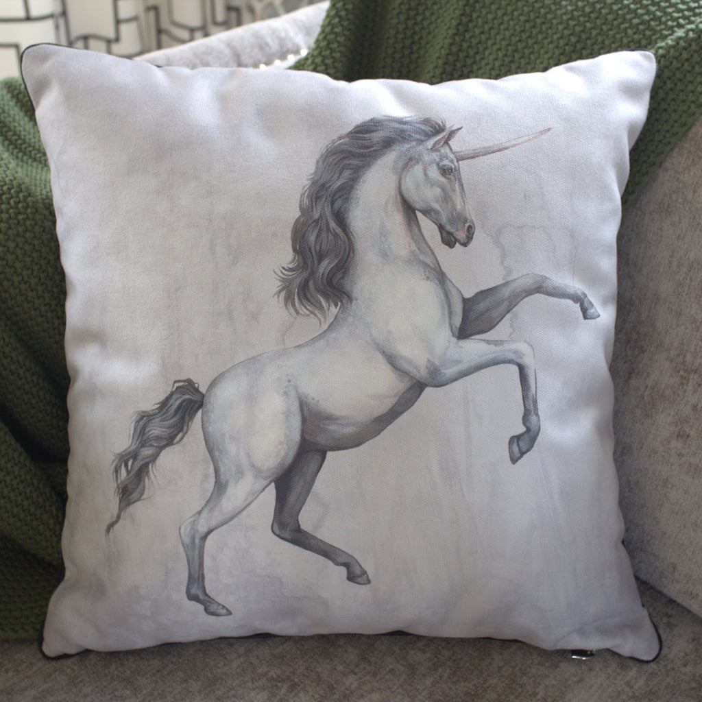 Pillow with a unicorn design on a couch
